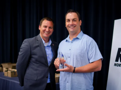 Nevin Martin (left), TSEP Executive Board Member and chair of TSEP’s Downtown Development Board, presents the Outstanding Business Award to Chris Chase, Owner of MST Pub.