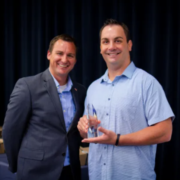 Nevin Martin (left), TSEP Executive Board Member and chair of TSEP’s Downtown Development Board, presents the Outstanding Business Award to Chris Chase, Owner of MST Pub.